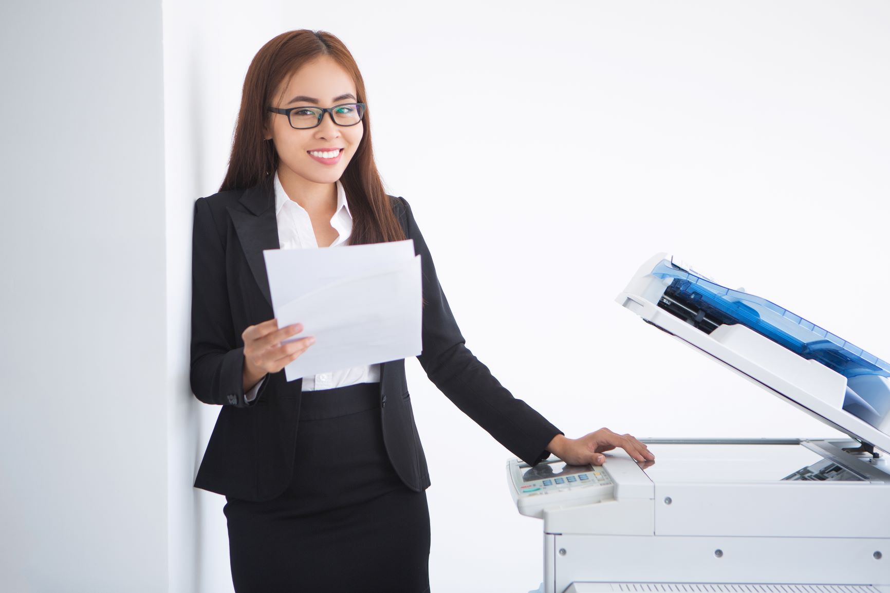 happy-beautiful-business-woman-standing-copier